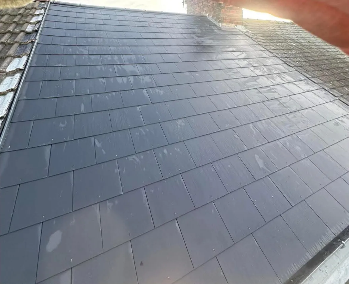New slate roof finished up to the chimney stack