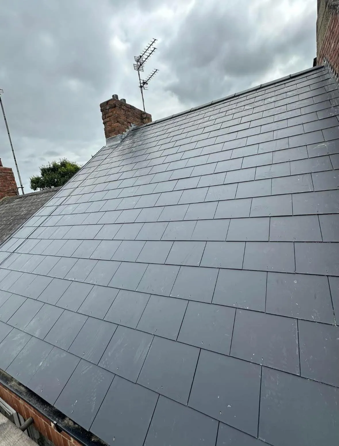 New slate roof with lead flashing detail at the chimney