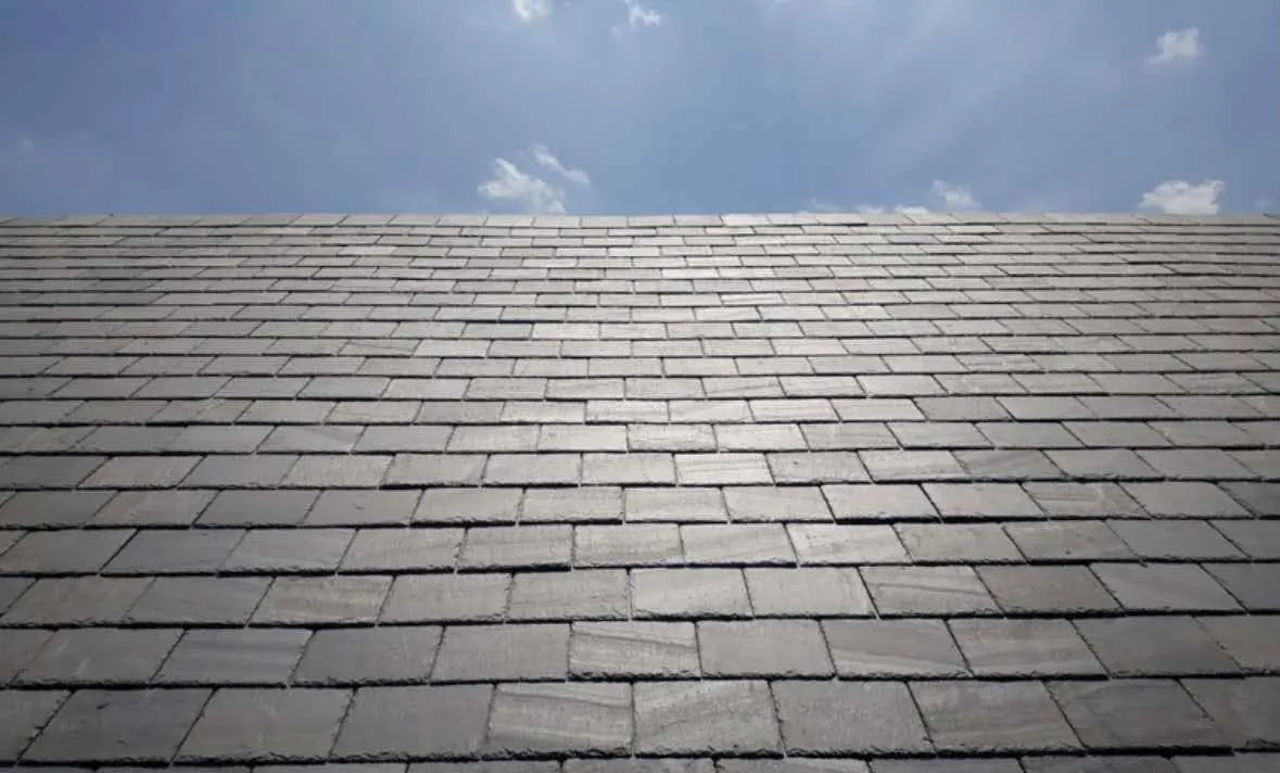 Close-up of a slate roof covering against a blue sky