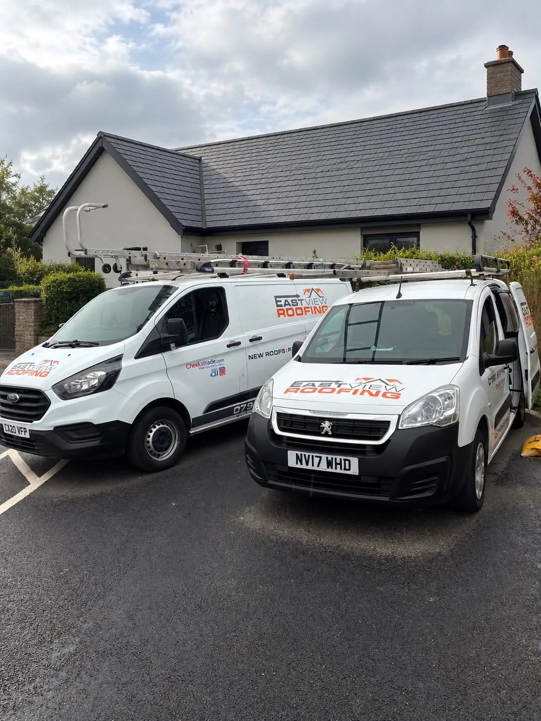 East View Roofing branded vans parked outside a bungalow with a newly tiled grey roof